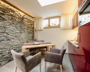 a kitchen and dining room with a table and chairs at Hotel Norica - Thermenhotels Gastein mit dem Bademantel direkt in die Therme in Bad Hofgastein