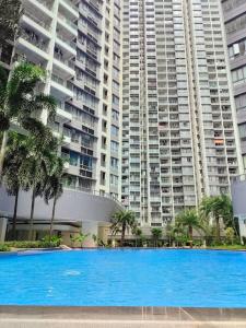 a large blue swimming pool in front of a large building at Sofia Superior Suite 2R2B-51902 at R&F Princess Cove in Johor Bahru