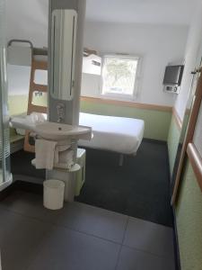 a bathroom with a sink and a mirror at SUN1 BLOEMFONTEIN in Bloemfontein