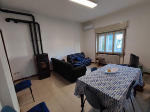 a living room with a table and a chair at Casa Zoe in Piacenza