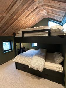 1 dormitorio con 2 literas y techo de madera en Norefjell Chalet, en Surteberg