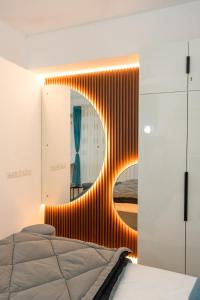 a bedroom with a mirror and a bed at Skystay Apartments in Lucknow