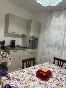 a kitchen with a table with a red purse on it at La casa al mare in Policoro