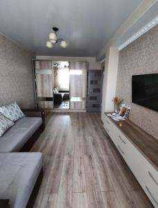 a living room with a couch and a flat screen tv at Ciocana apartament in Chişinău