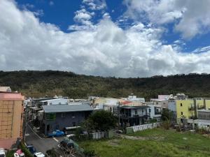 a group of houses in a city under a cloudy sky at 墾丁南灣包棟 光宿宅旅少人也可包棟 in Nanwan