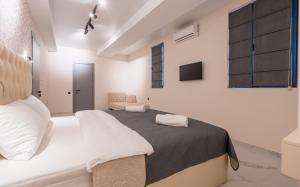 a bedroom with a large bed in a room at Luxury X By umbrella in Tbilisi City