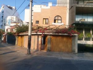 a building with flowers on the side of a street at Global Family Backpackers Hostel in Lima