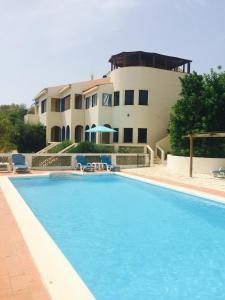 a swimming pool in front of a house at Quinta do Atlantico in Santa Bárbara de Nexe