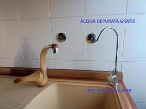 a sink with a faucet in a bathroom at Casa Zoe in Piacenza