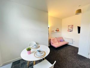 a living room with a table and a couch at Comfy Stylish 1BD Apt near Transport Links in Liverpool