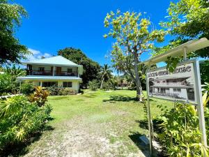 a house and a sign in front of a yard at Lucy's guesthouse in La Digue