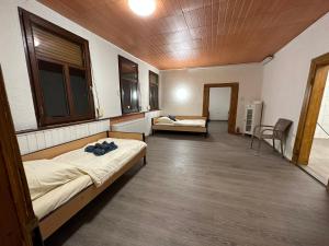 a room with two beds and a table and chairs at Belle Vue Apartrooms in Fürth