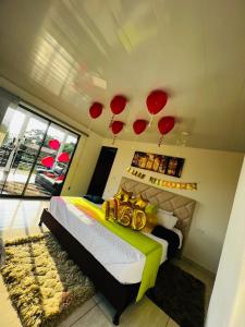 a bedroom with a bed with red balloons on the ceiling at finca hotel luzsagra in La Vega