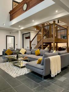 a large living room with couches and a clock at Capel Salem in Blaenau-Ffestiniog