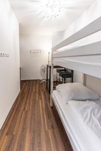 a bedroom with two bunk beds and a desk at CENTRAL & AFFORDABLE by JR City Apartments in Vienna