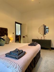 a bedroom with a bed with two towels on it at Capel Salem by Birch Stays in Blaenau-Ffestiniog