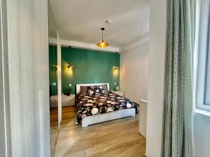 a bedroom with a bed and a green wall at Airport Stay Comfortable accommodation with own bathroom Easy access in Mqabba