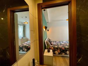 a reflection of a room with a bed in a mirror at Airport Accommodation Deluxe Bedroom and Private Bathroom near Airport Self Check In and Self Check Out in Mqabba