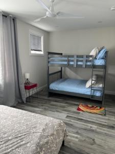 a bedroom with two bunk beds and a ceiling at New Walkerville Cozy Brownstones in Windsor
