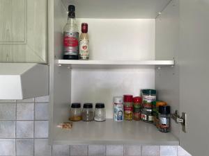 a kitchen pantry with spices and bottles in it at Linz Central Apartment in Linz