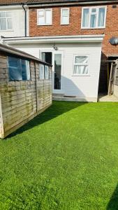 a house with a green lawn in front of it at COSY AND COMFY DOUBLE ROOM in London