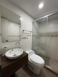 a bathroom with a toilet and a sink and a shower at HOSTELFC CORFERIAS in Bogotá