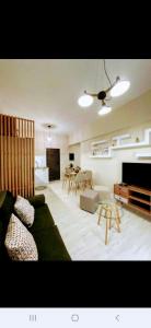 a living room with a couch and a table at Boboli Holiday House Acharavi Corfu in Acharavi