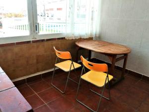 a table and two chairs in a room with a table at Roses, Puig Rom in Roses