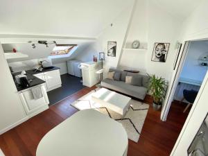ein Wohnzimmer mit Sofa und Tisch in der Unterkunft Magnifique 2 pièces Theatre de Boulogne in Boulogne-Billancourt