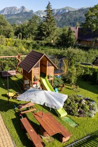 a small play house with a tent and a playground at Topór Apartament rodzinny z kominkiem i placem zabaw Kościelisko Zakopane in Kościelisko