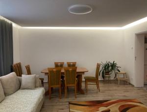 a living room with a couch and a table and chairs at Serce Jury in Ogrodzieniec