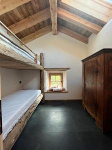 een slaapkamer met 2 stapelbedden en een raam bij Brand new duplex in the Dolomites - Lupo Bianco in Rocca Pietore