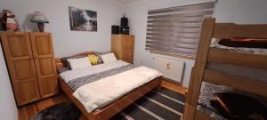 a bedroom with a bed and two bunk beds at Apartman Jonjić in Kupres