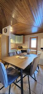 a dining room with a wooden table and chairs at La Baita Residence 3.0 in Folgarida +14 photos