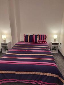 a bedroom with a large bed with two night stands at 1 Bedroom Flat Available in Oldham