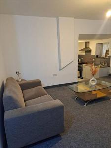 a living room with a couch and a coffee table at 1 Bedroom Flat Available in Oldham