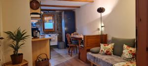 Una sala de estar con un sofá y una mesa y una cocina. en Ferienwohnung am Bächelweg, en Bad Schandau