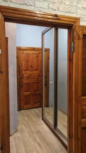 a room with a mirror and a wooden door at Cozy apartment near city center on Peremogy Avenue 44, bus and railway station nearby in Chernihiv