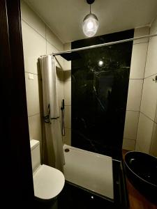 a small bathroom with a toilet and a shower at Airport Accommodation Bedroom with your own private Bathroom Self Check In and Self Check Out Air-condition Included in Mqabba