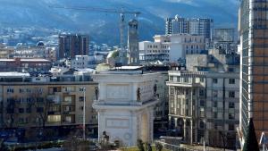 een uitzicht op een stad met gebouwen en een kraan bij MINA modern & cozy apartment main city square GTC Skopje in Skopje