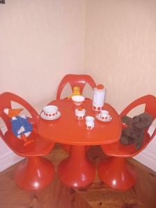 a red table with cups and teddy bears on it at Vintage ,le paradis des enfants wifi draps parking free in Thiers