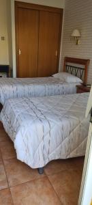 Posteľ alebo postele v izbe v ubytovaní Hostal Mont-Rock