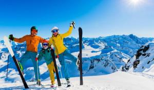 a group of three people standing on top of a snow covered mountain at Superbe appartement en résidence avec piscine. in Albertville