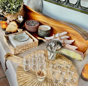 a table with plates and glasses on a table at Bed & Breakfast Casa del Palta in Canillas de Albaida