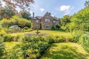 an old house with a garden in front of it at Mireystock Indoor Pool, Games Bar, Spa Steam Cabin in Lydbrook