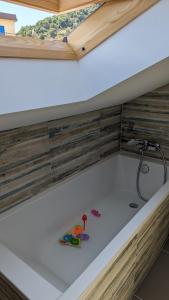 a bath tub with a sink in a room at "SALERNO" Apartament w GIFFONI VALLE PIANA dla 6 osób, klimatyzowany, w pełni wyposażony in Giffoni Valle Piana