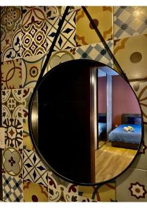 a mirror on a wall with a bed in a room at Airport Accommodation Bedroom with your own private Bathroom Self Check In and Self Check Out Air-condition Included in Mqabba