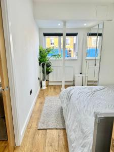 a bedroom with a bed and a window at The Modern Smart Home in Great Warley Street