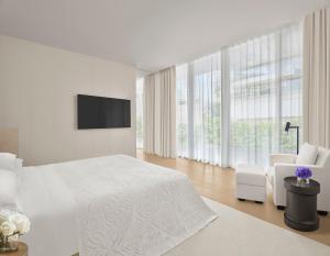 Cama ou camas em um quarto em The Singapore EDITION