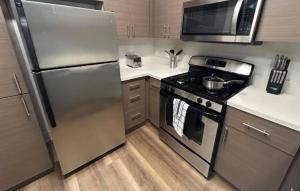 a kitchen with a stainless steel refrigerator and a stove at Westerly 2 bedroom apartment Marina Del Rey near Venice beach! in Los Angeles